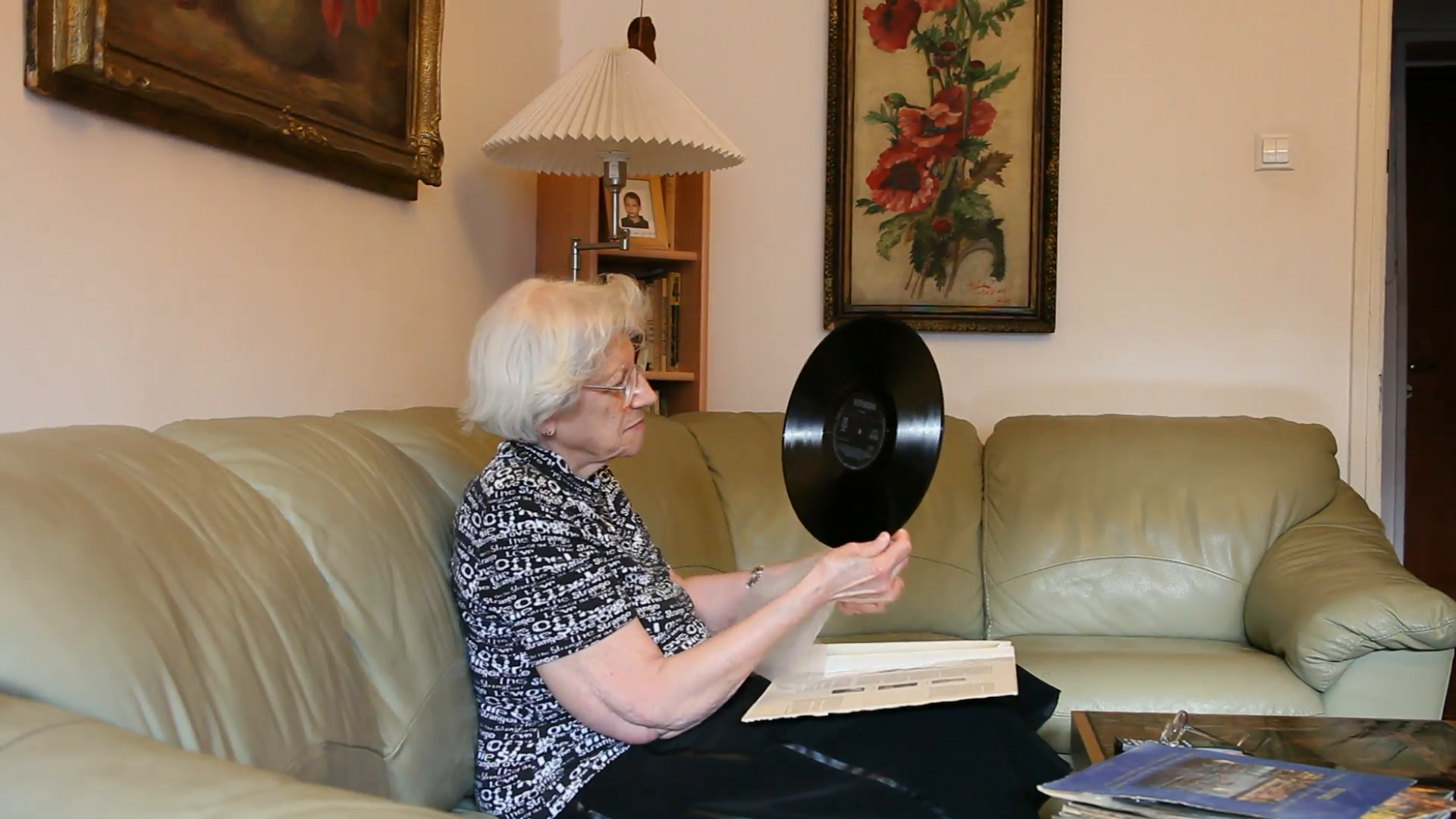 elderly-woman-looking-at-old-vinyl-records-on-a-couch-music-old-fashioned_4yxum_eml__F0000.png