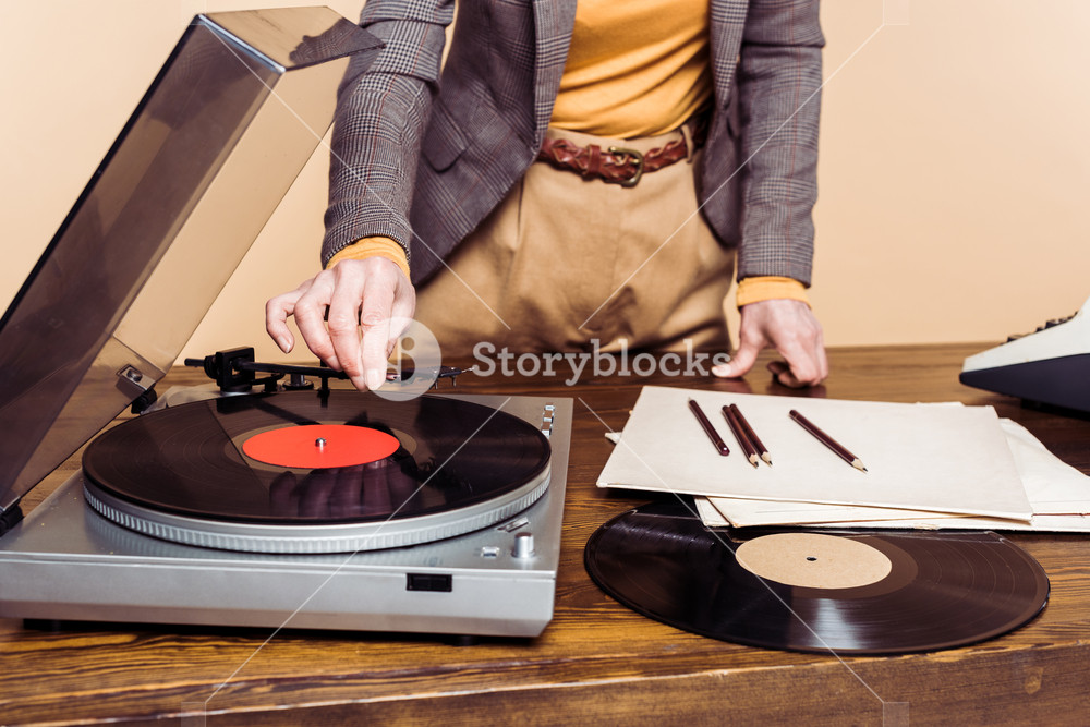 storyblocks-cropped-image-of-woman-turning-on-vinyl-record-player_S0u4fU_K7_SB_PM.jpg