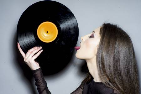 101153994-sexy-woman-lick-vintage-vinyl-disc-woman-with-makeup-face-hold-vinyl-record-fashion-...jpg