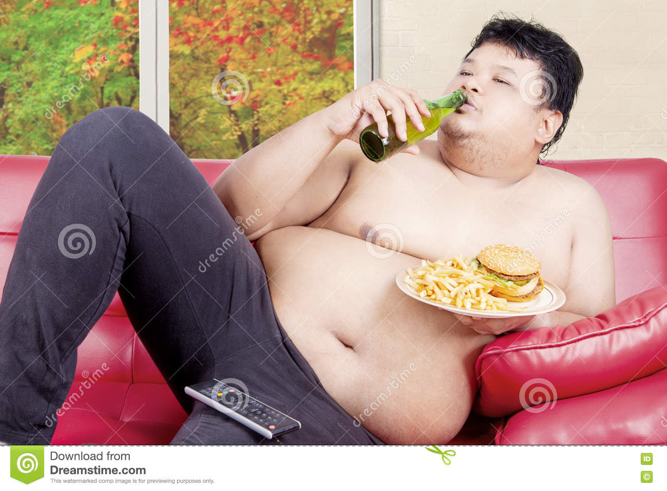 overweight-man-drinking-eating-couch-young-reclining-junk-food-autumn-background-window-79142779.jpg
